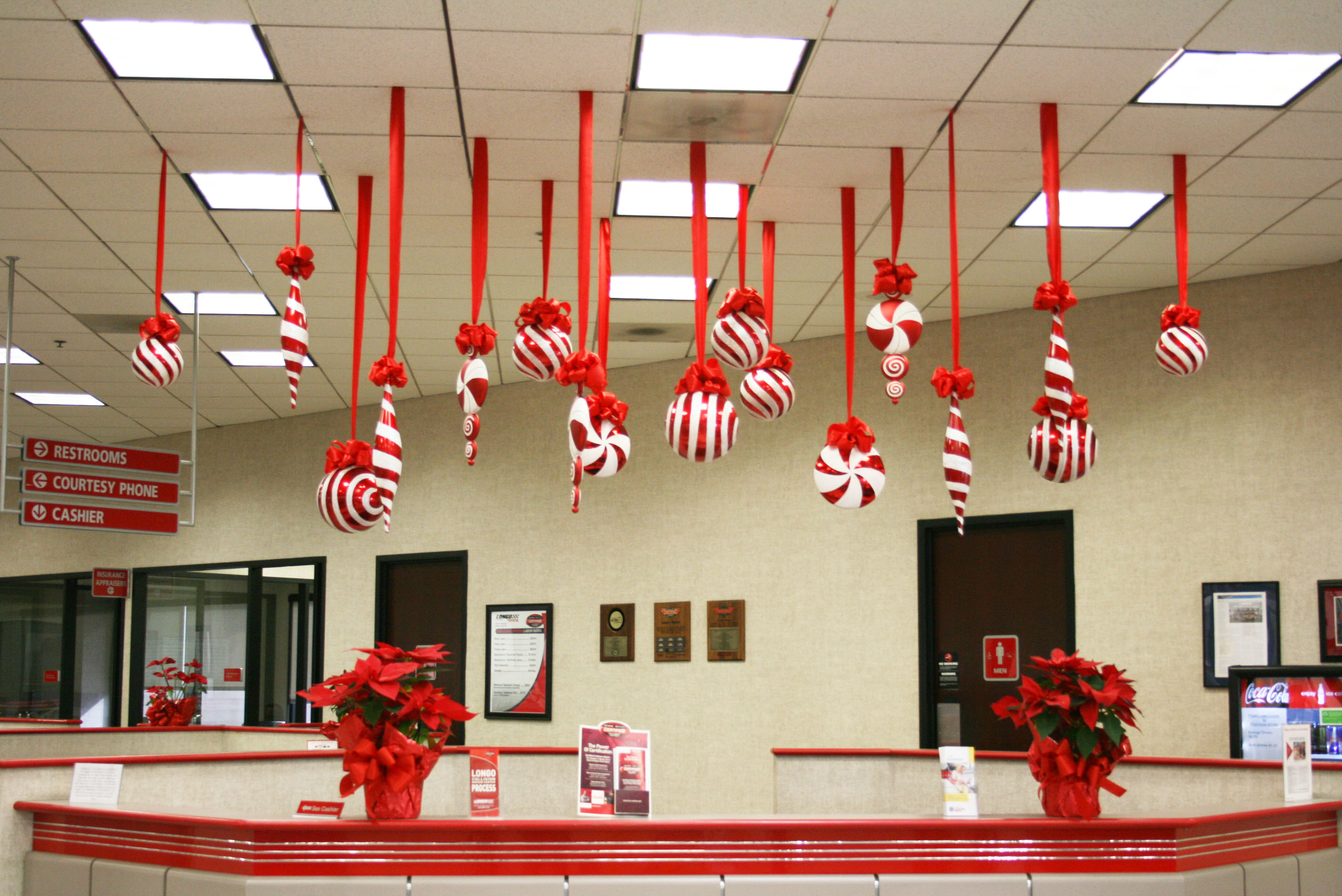 ideas-inspiration-beautiful-handcrafted-red-ribbon-hanging-on-white-ceiling-over-counter-desk-office-as-christmas-office-decoration-ideas-spellbinding-christmas-office-decoration-themes-and-pictures