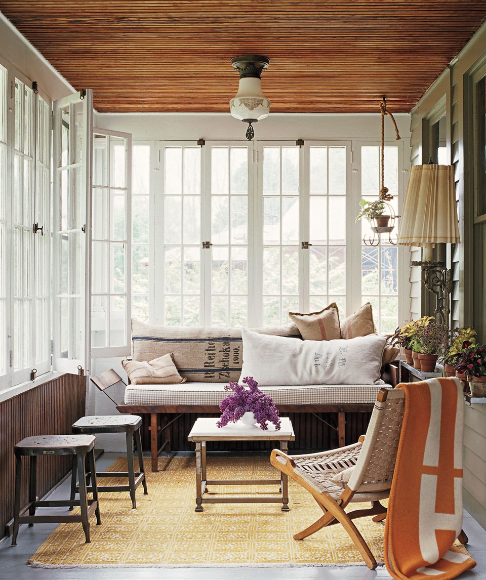 artistic-sunroom-design-with-white-windows-and-wood-ceiling-above-rustic-wooden-bench