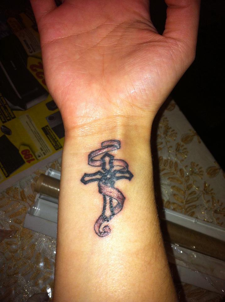 Christian-Cross-With-Ribbon-Tattoo-On-Wrist.