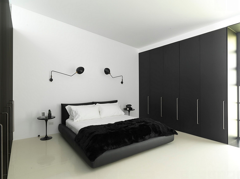 Minimal-bedroom-in-black-and-white-with-wall-sconces-and-Tulip-side-table