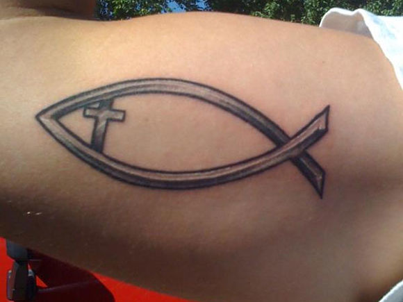 grey-ink-cross-and-jesus-fish-tattoo-on-biceps_