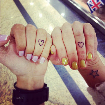 Small-heart-tattooed-on-ring-finger-and-star-on-wrist-looking-awesome.