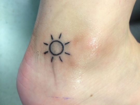 small-sun-tattoo-designs-on-outer-Ankle.