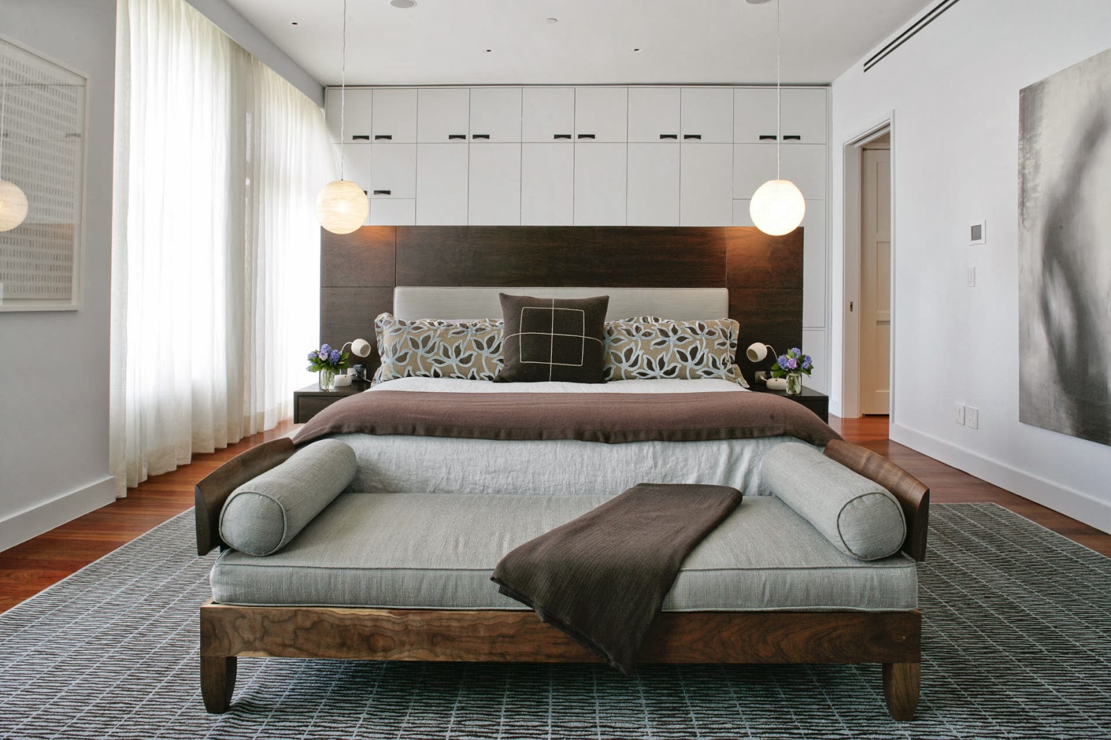 luxury master bedroom with a sofa at the foot of the bed as one of the eclectic elements in the space (1)
