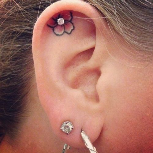 Small-Flower-Tattoo-And-Dermal-Anchor-Inside-Ear-Piercing.