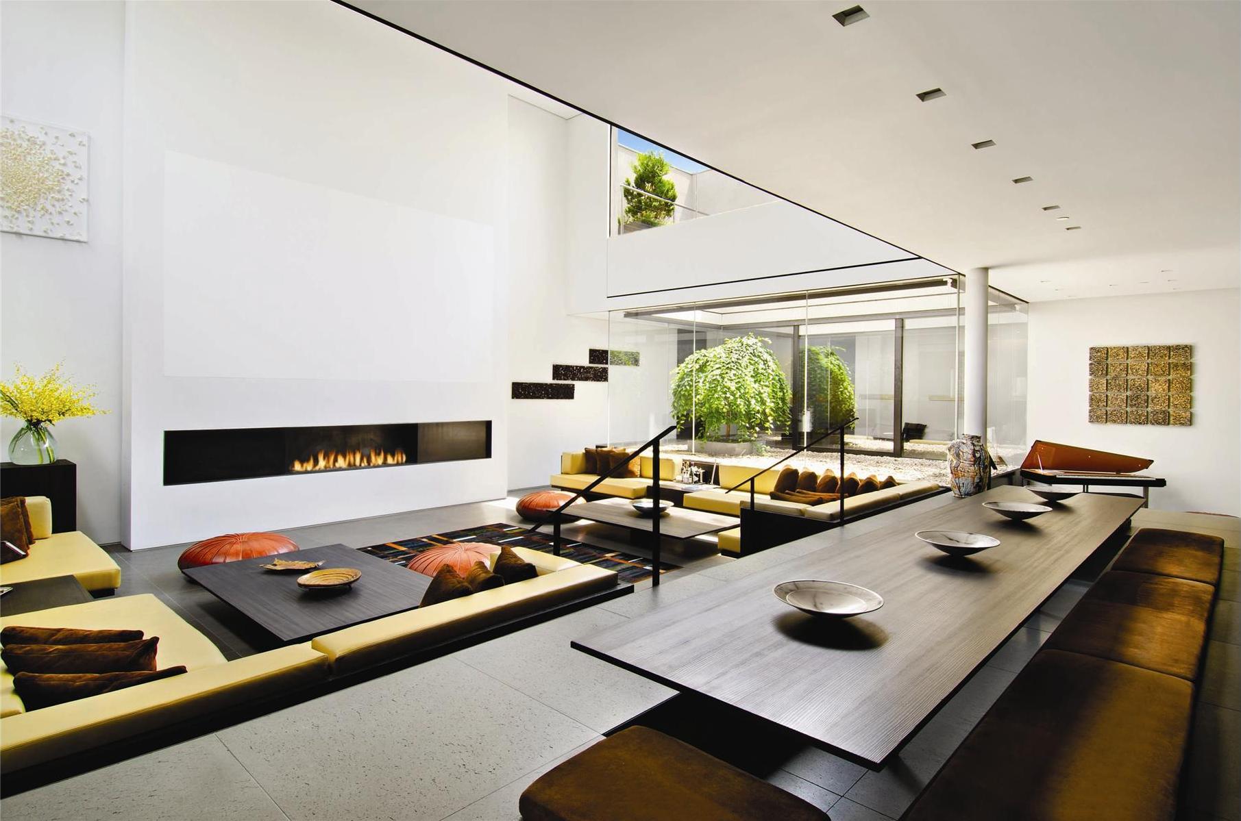 modern-living-room-of-penthouse-design-with-slim-wood-table-and-cool-fireplace-turns-in-white-wall.