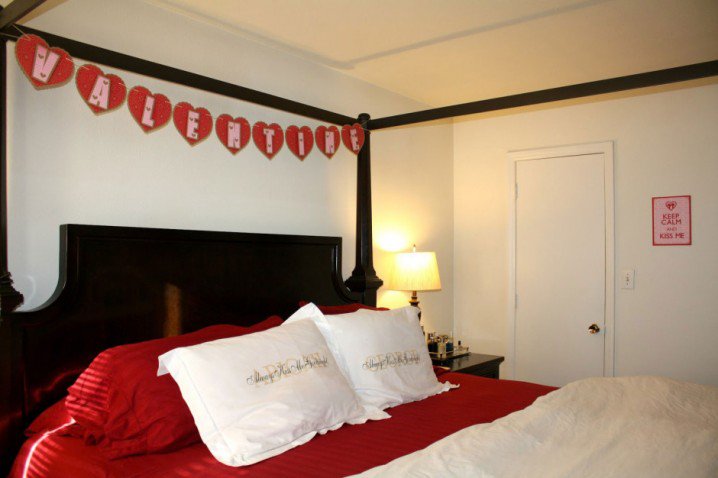 alluring-valentine-bedroom-design-with-valentine-banner-on-canopy-bed-and-impressive-red-bed-also-white-pillows-and-white-wall-painting
